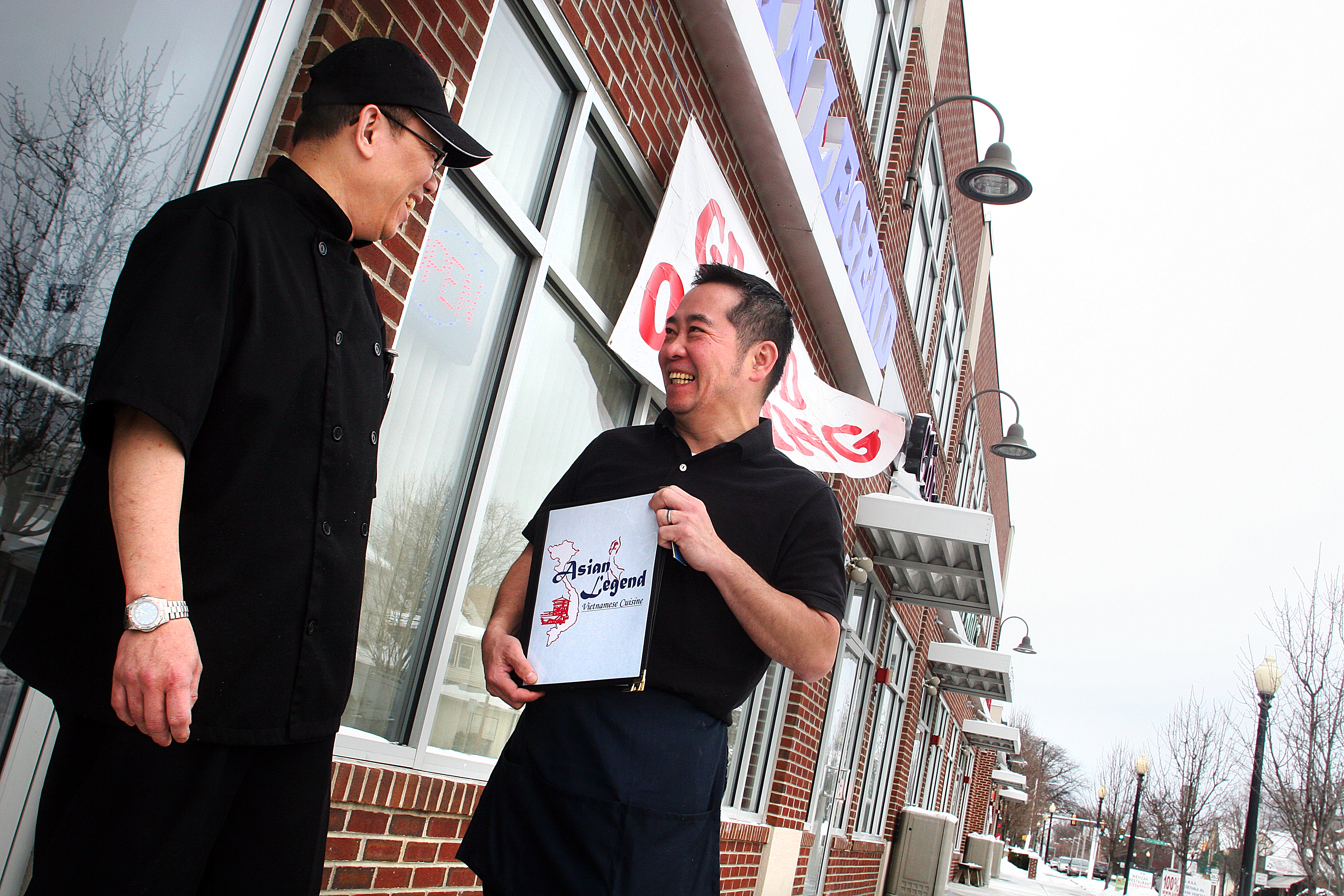 Man Showing Another Man a Menu